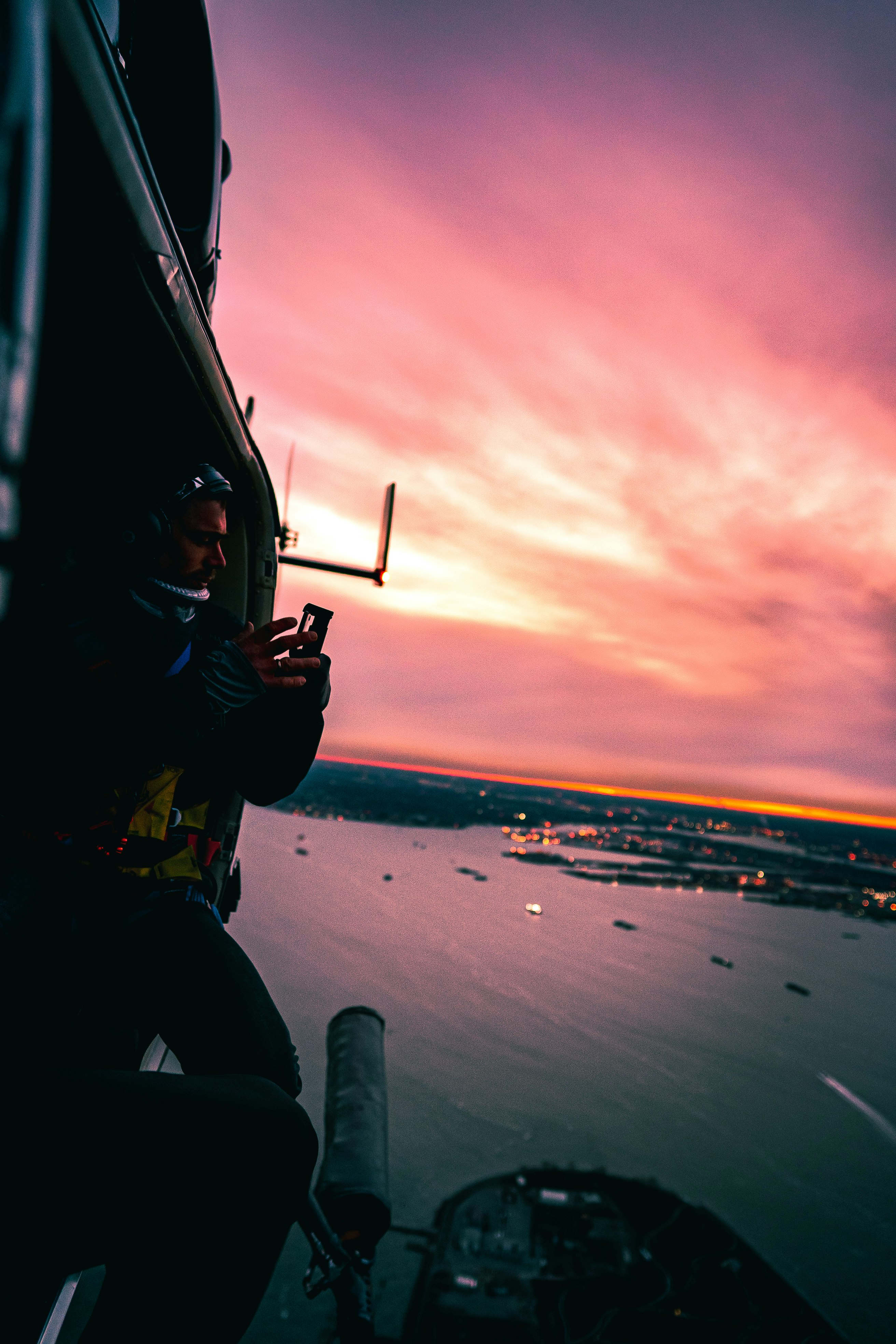 man in helicopter taking photo